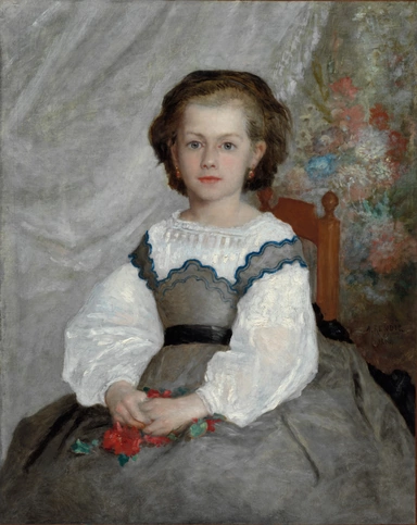 A young girl sits facing us in a white dress with a blue-trimmed lace collar and a wide grey skirt, a few red flowers held in her lap, against a pale grey wall with a flowering shrub behind her shoulder.